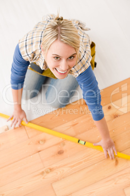 Home improvement - handywoman installing wooden floor