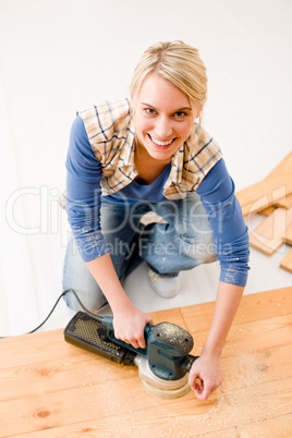 Home improvement - handywoman sanding wooden floor