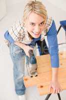 Home improvement - handywoman cutting wooden floor