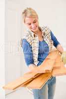 Home improvement - handywoman carry wooden plank