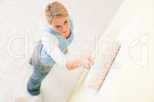 Home improvement - handywoman painting wall