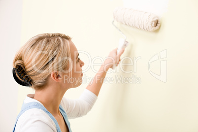 Home improvement - handywoman painting wall