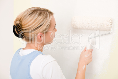 Home improvement - handywoman painting wall