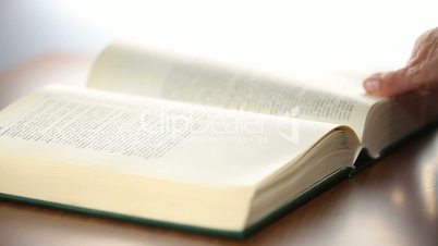 Bible Book scrolling by woman hand