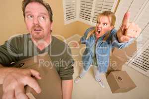 Stressed Man Moving Boxes for Demanding Wife