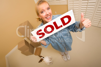 Woman and Doggy with Sold Sign Near Moving Boxes