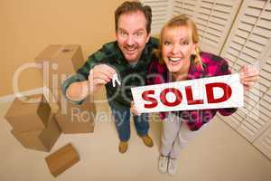 Goofy Couple Holding Key and Sold Sign Surrounded by Boxes