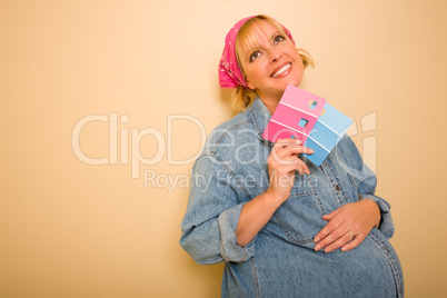 Pensive Pregnant Woman Holding Pink and Blue Paint Swatches.