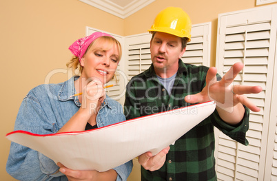 Contractor in Hard Hat Discussing Plans with Woman