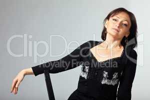 mature woman sit on chair in lace jacket