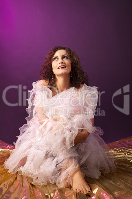 Beauty woman in ballet tutu sit and smile