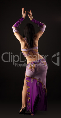 Woman dance in traditional arabian costume - back