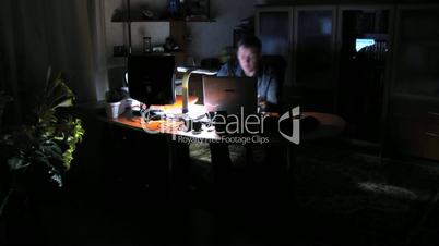 time lapse. man works behind computers.