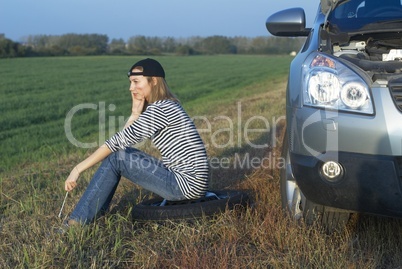 Young Blond Woman With Her Broken Car