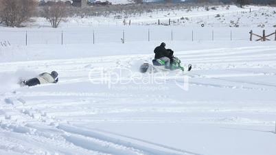 Snowmobile pulling a sled P HD 8564