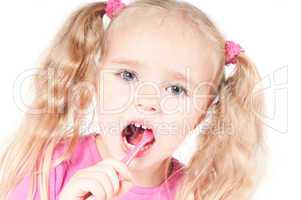Little cute girl in studio brushing teeth