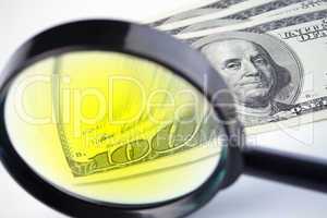 Dollars under a magnifying glass