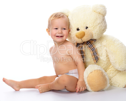 Happy child with big soft bear toy
