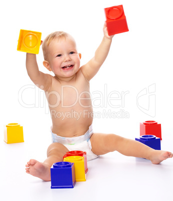 Happy little boy with building bricks