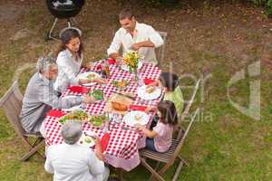 Family eating outside in the garden