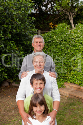 Grandparents with their grandchildren looking at the camera