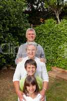 Grandparents with their grandchildren looking at the camera