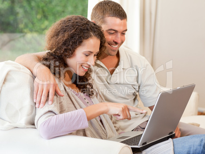 Couple working on their laptop at home