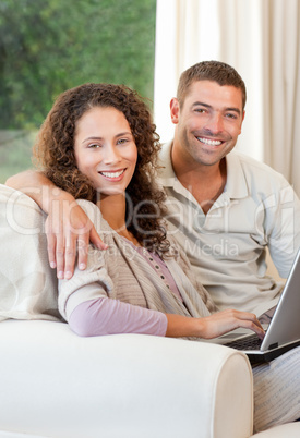 Couple working on their laptop at home