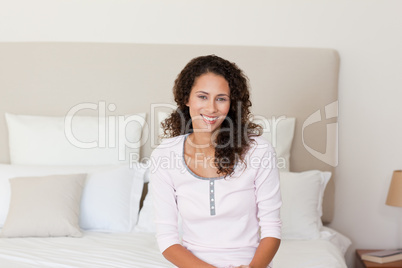 Beautiful woman lying down on her bed at home