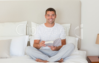 Man reading a book on the bed