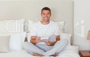 Man reading a book on the bed