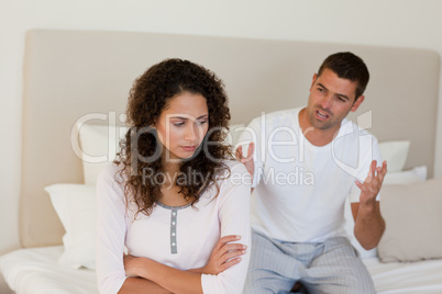 Young couple having a dispute on the bed