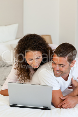 Lovely couple looking at their laptop