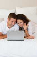 Lovely couple looking at their laptop