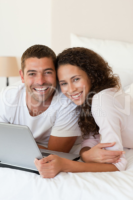 Lovely couple looking at their laptop