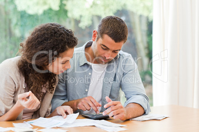 Young couple calculating their domestic bills