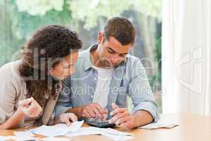 Young couple calculating their domestic bills