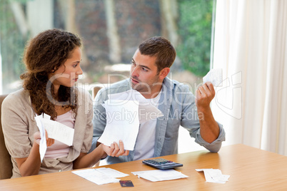 Young couple calculating their domestic bills