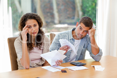 Young couple calculating their domestic bills