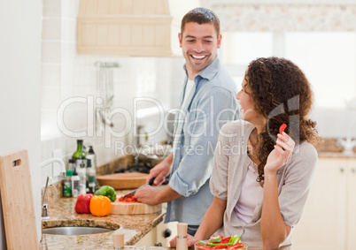 Beautiful woman looking at her husband who is cooking