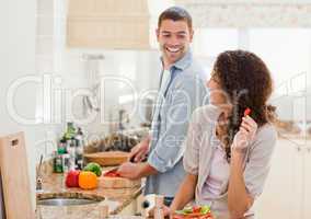 Beautiful woman looking at her husband who is cooking