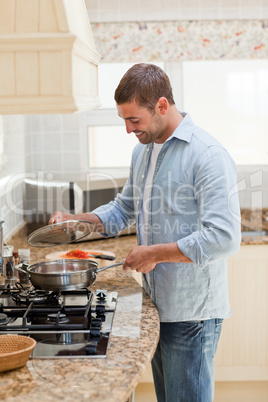 Handsome man cooking in the kitchen