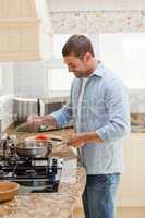 Handsome man cooking in the kitchen