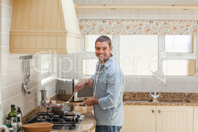 Handsome man cooking in the kitchen