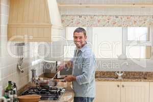 Handsome man cooking in the kitchen