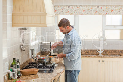 Handsome man cooking in the kitchen