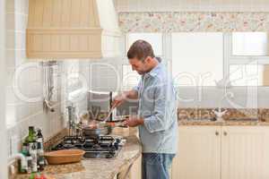 Handsome man cooking in the kitchen