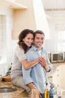 Beautiful couple hugging in the kitchen