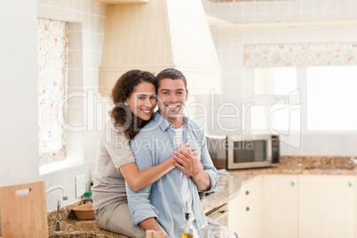 Beautiful couple hugging in the kitchen