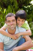 Father with his son hugging in the garden